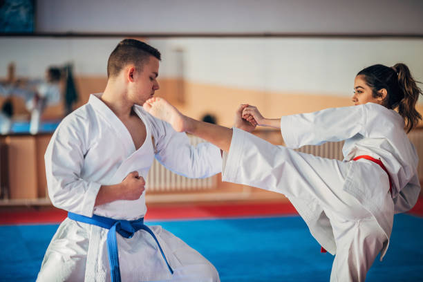 istock Young woman and young man training karate together 1249986757