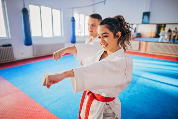 istock Young woman and young man training karate 1249986819