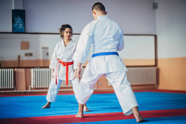 istock Young woman and young man on karate practice 1249986882