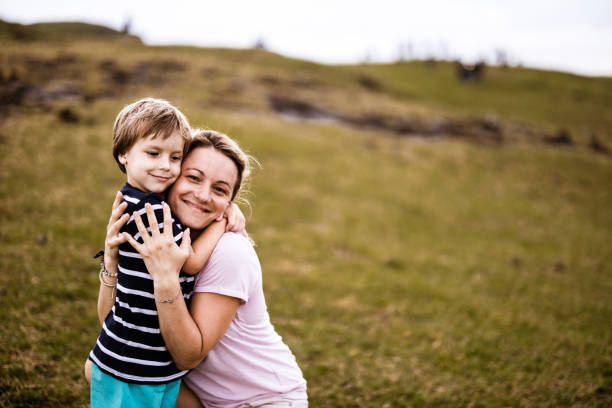 istock Loving single mother and her son embracing in nature. 1249986889
