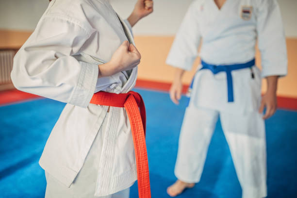 istock Young man and woman training karate together 1249986925