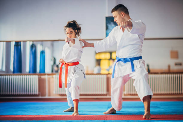 istock Young male karate trainer and female student on karate practice 1249987555