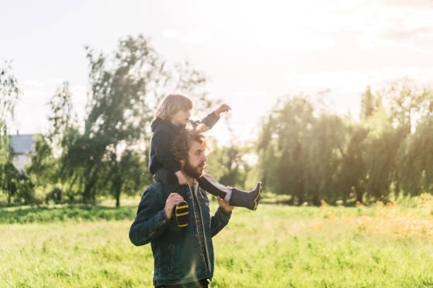 istock Caucasian man carrying baby boy on shoulders 1249992984