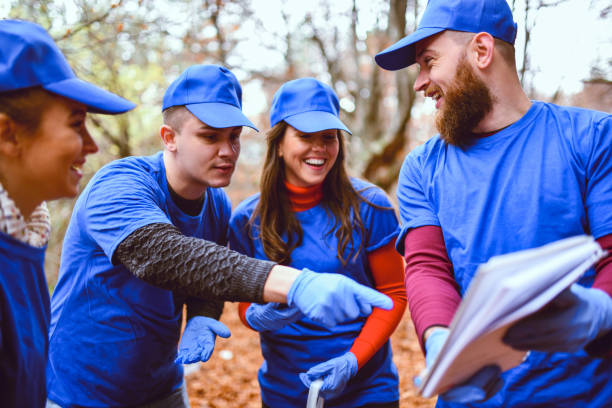 istock Environmental Volunteers Checking Daily Tasks In Notebook 1249994421