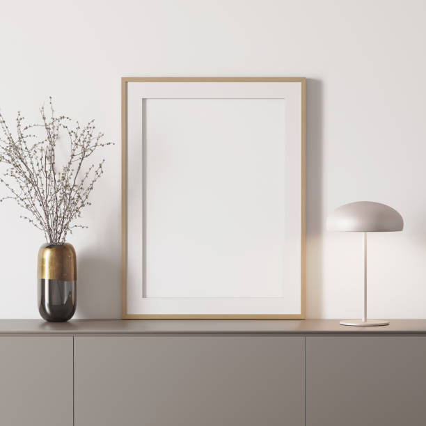 3d modern mockup with frame on a grey sideboard 3d white modern mockup with blank framed canvas on a grey sideboard, branches in a gold vase sideboard photos stock pictures, royalty-free photos & images