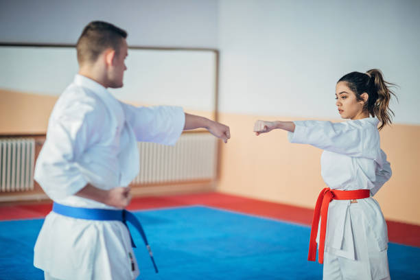 istock One young woman and one young man training karate 1249996468