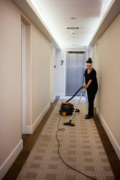 istock Maid vacuuming hotel corridor , wearing a face mask while working at a hotel 1249997724