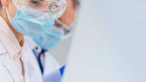 istock close up. female scientist in a protective mask 1250000656