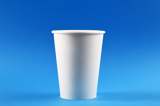 A paper coffee cup on blue background