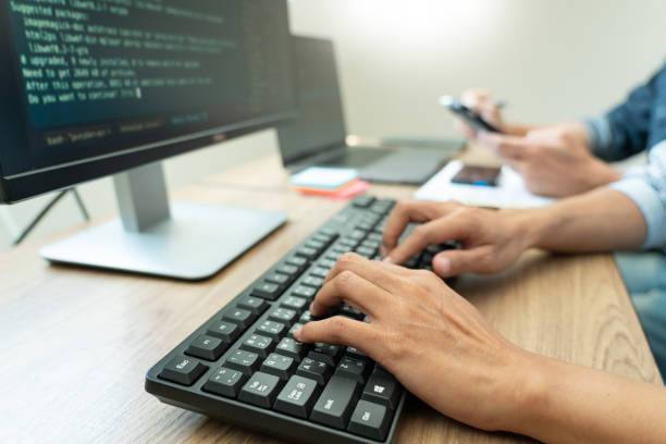 Programmers Using Computers In Office  java programming langauge stock pictures, royalty-free photos & images
