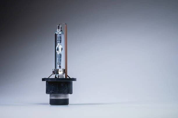 Xenon is a new lamp for automotive headlights on a gray gradient background. Gas-discharge lighting devices stock photo