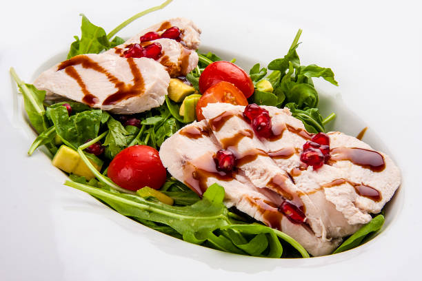 Salad with chicken with pomegranate sauce on a white background
