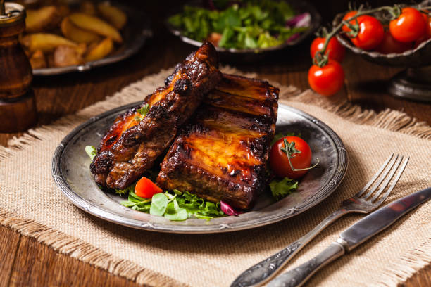 istock Roasted ribs, served on an old plate. Dark or balck background. 1250004466