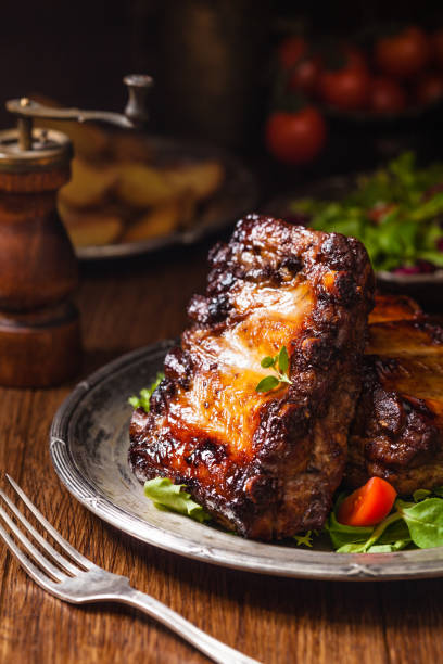 istock Roasted ribs, served on an old plate. Dark or balck background. 1250004543