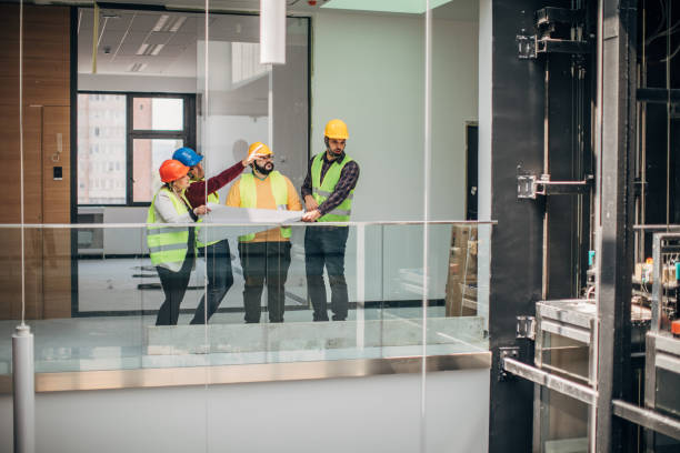 istock Engineers and architects looking at building blueprint at the construction site 1250005858