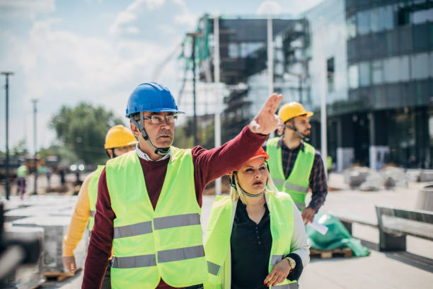 istock Engineers and architects walking at the construction site outdoors 1250006085