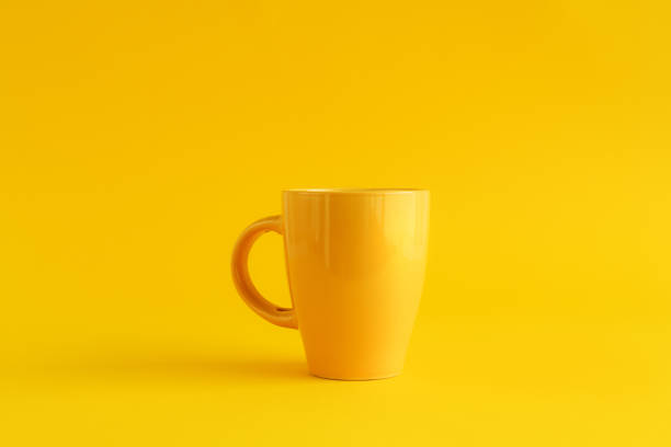 istock Single yellow coffee cup on yellow background 1250006619