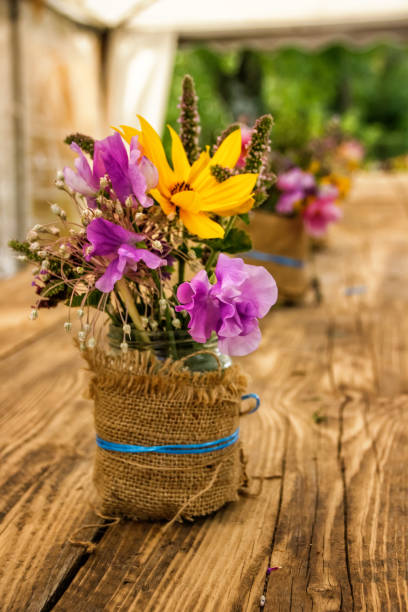Flowers in a jar on a wooden table