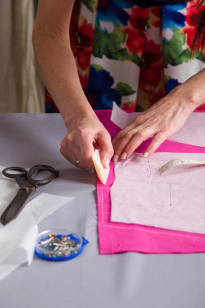 istock Sewing workshop. Tailor's mannequin. Knocking material on the dummy, before the fitting. 1250010018