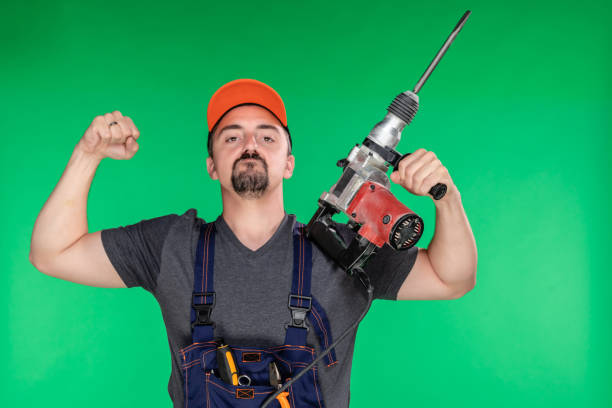 istock Construction worker with drilling machine show muscles on green background 1250010542