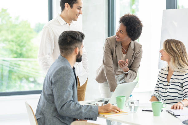istock Colleagues sitting in a small group discussing something while working at an office 1250012847