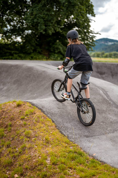 istock Young girl riding bmx bicycle 1250013172
