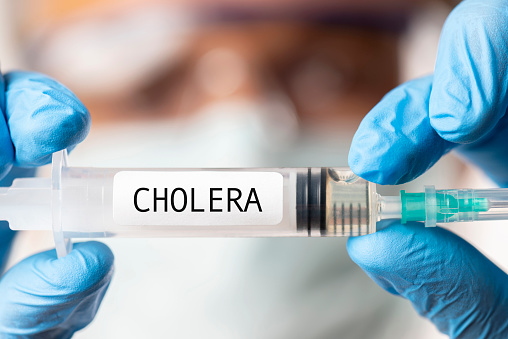 Doctor showing Cholera Vaccine.