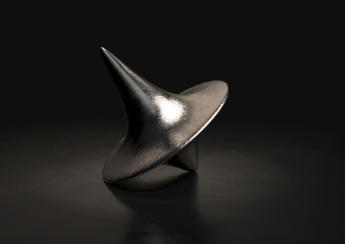 A slightly scratched die-cast lead spinning top in a resting position on a dark background - 3D render