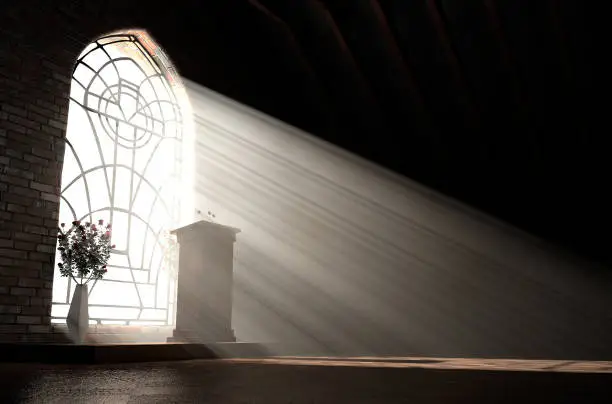 A dark church interior lit by suns rays penetrating through a glass window in the pattern of a crucifix shining on a speech pulpit - 3D render