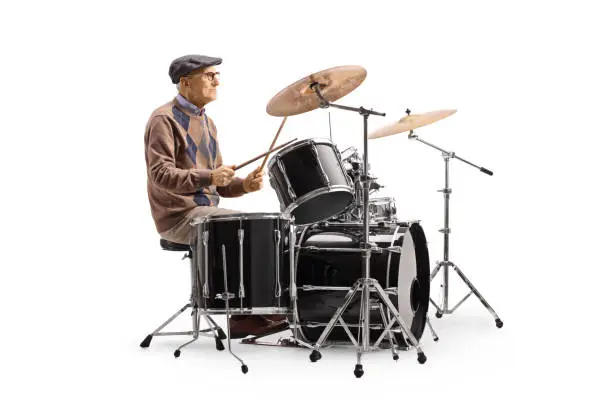 Photo of Elderly man playing a drum set