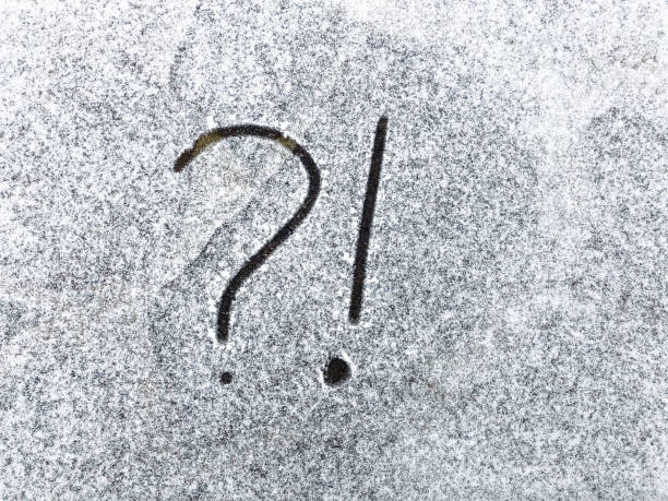 istock Question mark and exclamation mark on snowy surface close-up. Copy space. Confusion situatio 1250023645