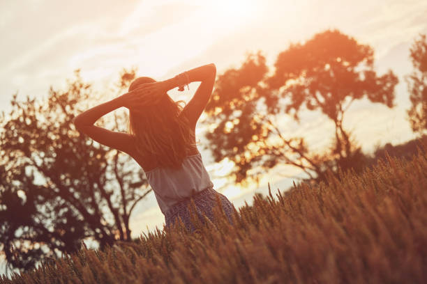 istock Young woman enjoying in a wheat field. 1250024181