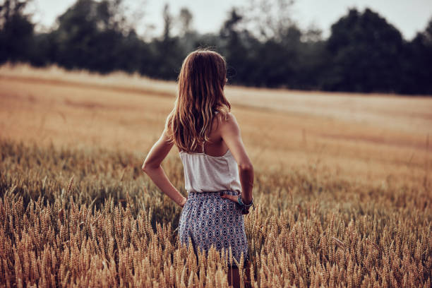 istock Young woman enjoying in a wheat field. 1250024244