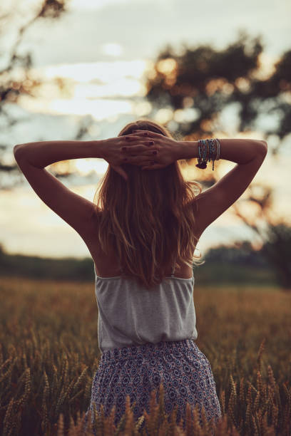 istock Young woman enjoying in a wheat field. 1250024270