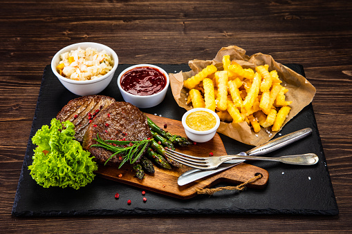 Grilled steak with French fries and asparagus