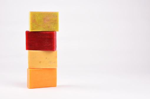 Group of multi colored natural soap bars on the white background with copy space