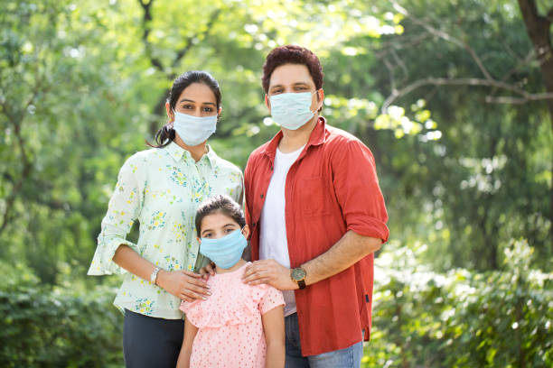 istock Family with protective face mask at park 1250025748