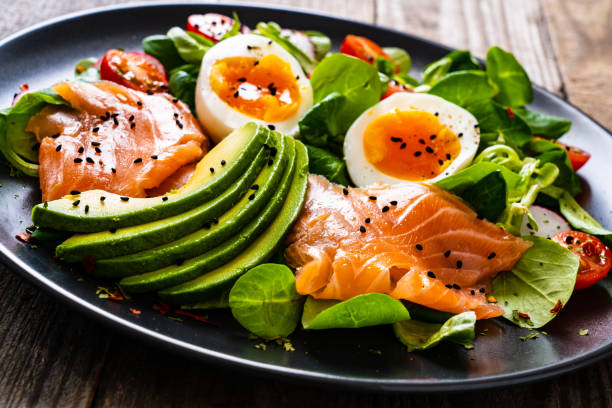 istock Smoked salmon with boiled eggs, avocado and vegetables on wooden table 1250026908