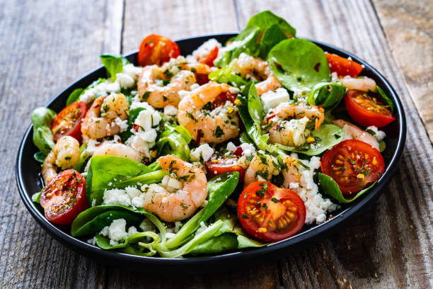 istock Prawns with vegetables on wooden table 1250027081