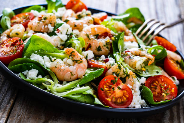 istock Prawns with vegetables on wooden table 1250027109