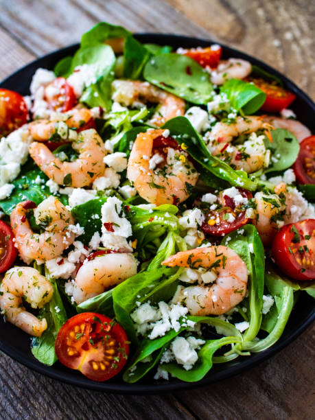 istock Prawns with vegetables on wooden table 1250027153