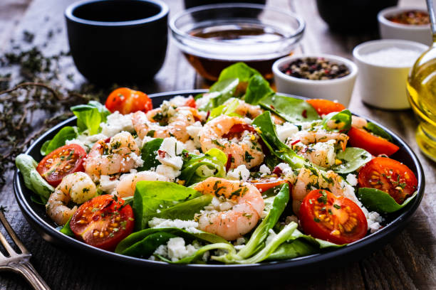 istock Prawns with vegetables on wooden table 1250027185