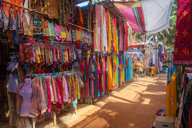 Indian bazaar benches with colorful saris Indian bazaar benches with colorful saris and dresses, Day Market, Anjuna, Goa india jaipur rajasthan traditional culture stock pictures, royalty-free photos & images