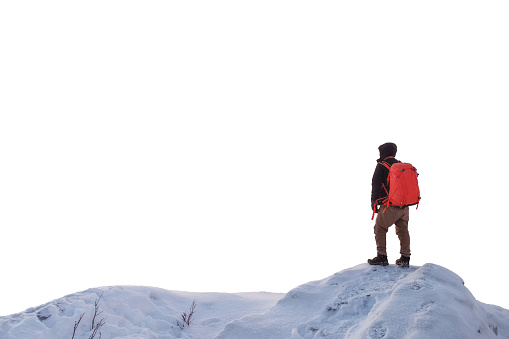 Man backpacker standing on snowy ridge hill. on white background
