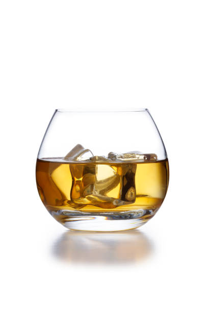 a isolated bowl style glass of whisky and ice, shot on white - brandy bottle alcohol studio shot imagens e fotografias de stock