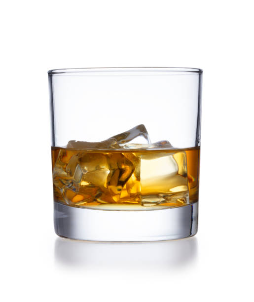 a isolated tumbler style glass of whisky and ice, shot on white - brandy bottle alcohol studio shot imagens e fotografias de stock