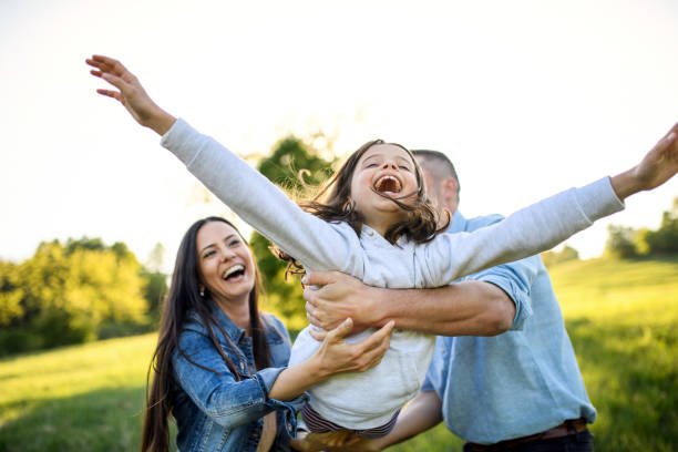 istock Happy family with small daughter having fun outdoors in spring nature. 1250031410