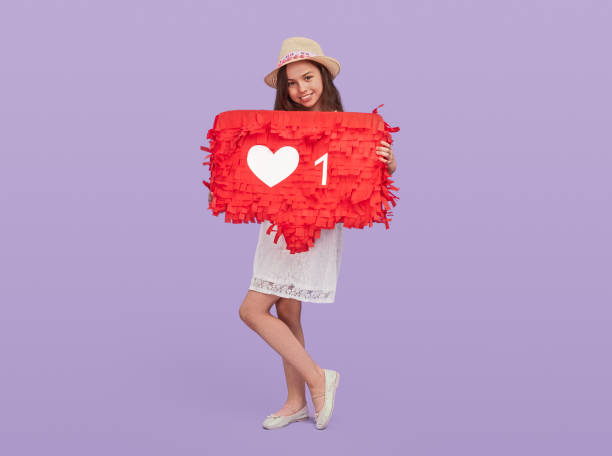 istock Girl holding speech bubble with like icon 1250031527