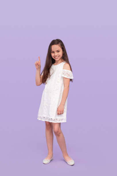 istock Optimistic girl smiling and pointing up 1250031530