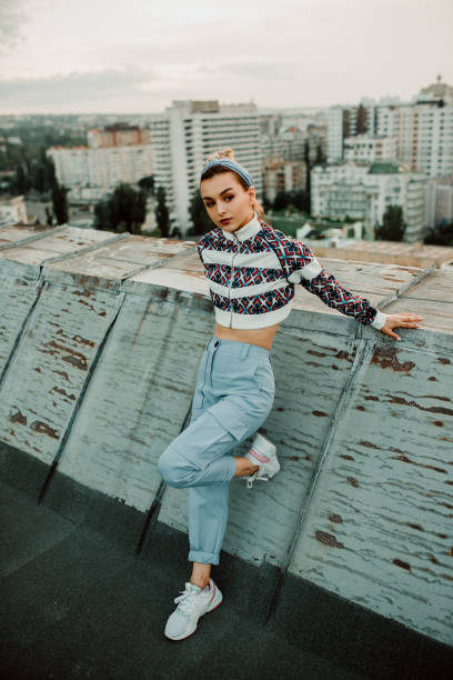 istock Stylish woman leaning on weathered barrier 1250032125